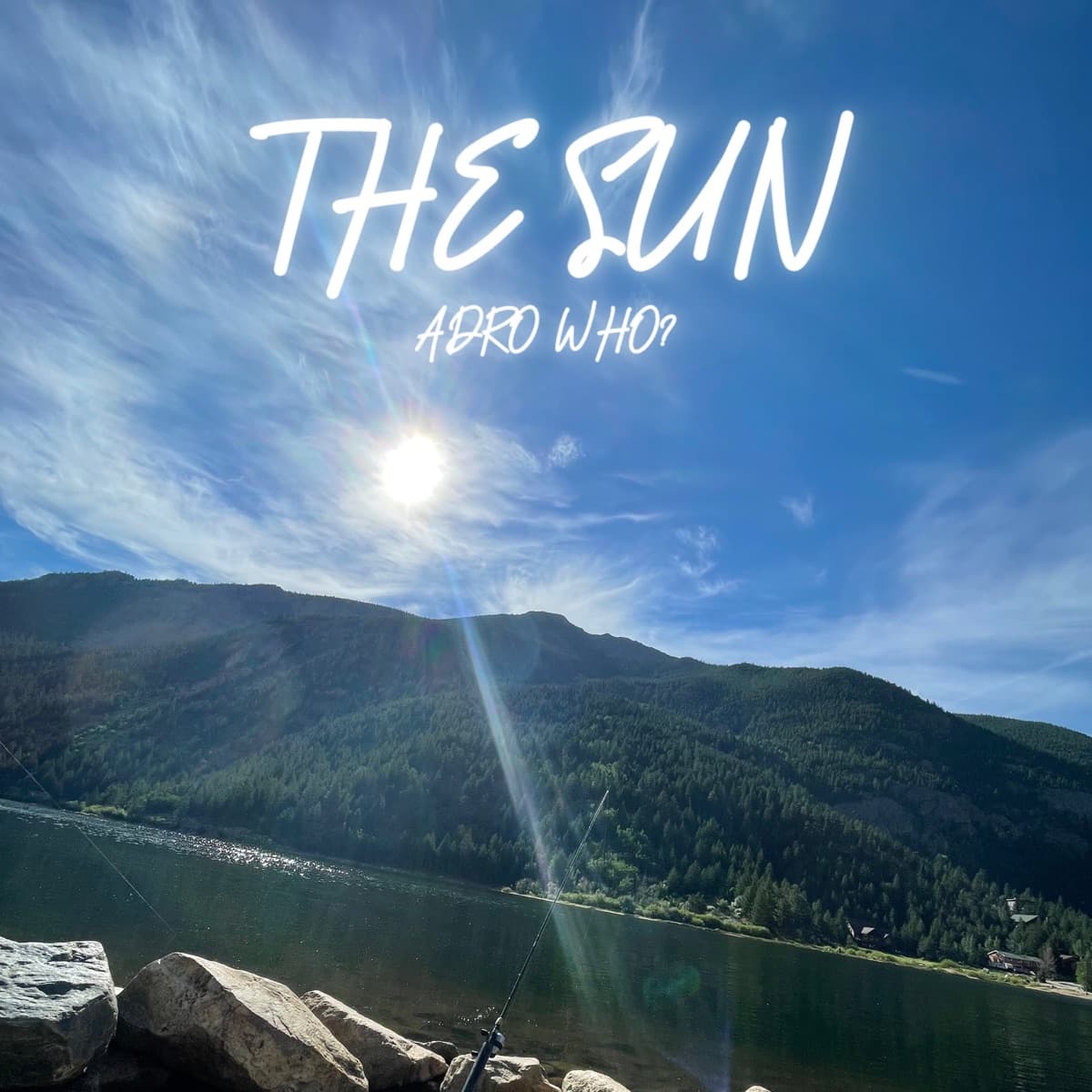THE SUN cover: sun over a mountain lake with the title handwritten in the sky